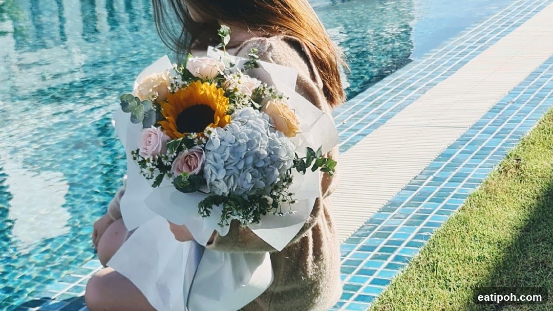 Person by Pool Holding Bouquet