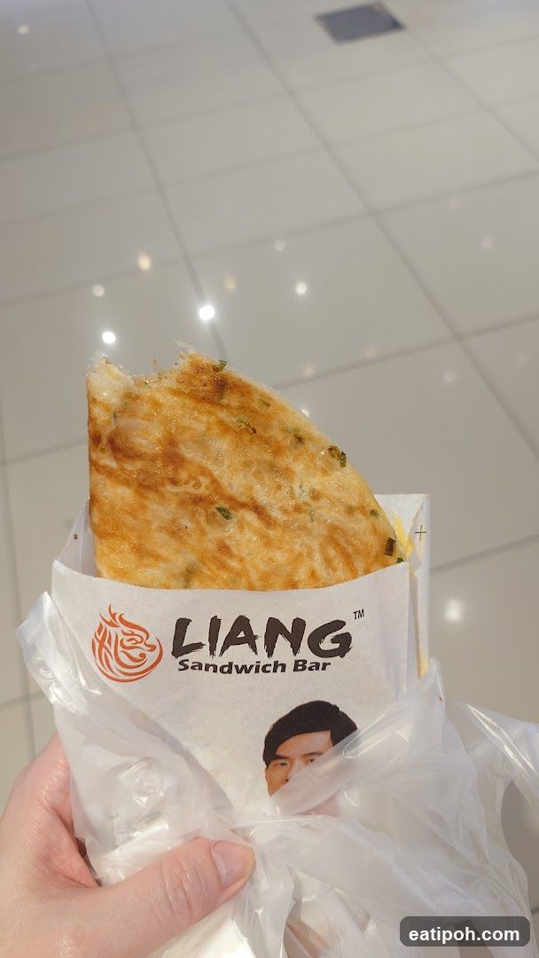 Hand holding food from Liang Sandwich Bar