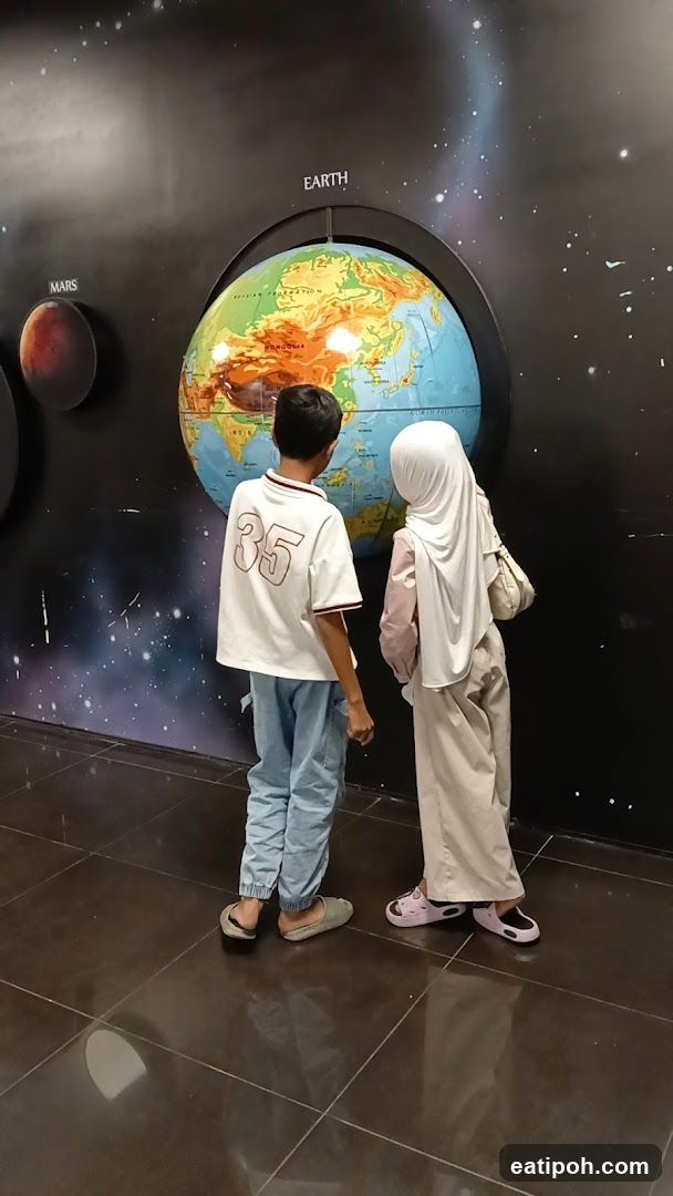 Children viewing globe exhibit