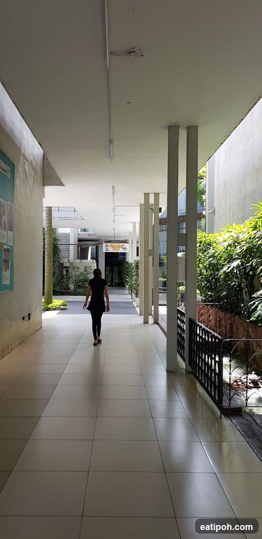 Person walking in covered corridor