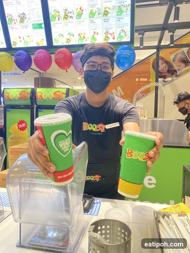 BOOST Juice Bars Staff Member Holding Drinks
