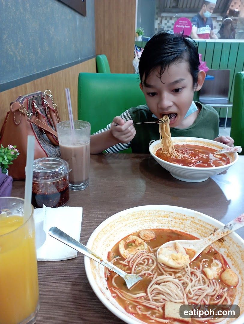 Child eating noodles in restaurant