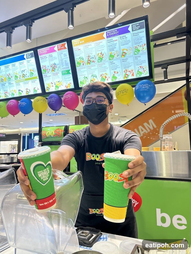 Boost Juice Bar Employee Holding Drinks