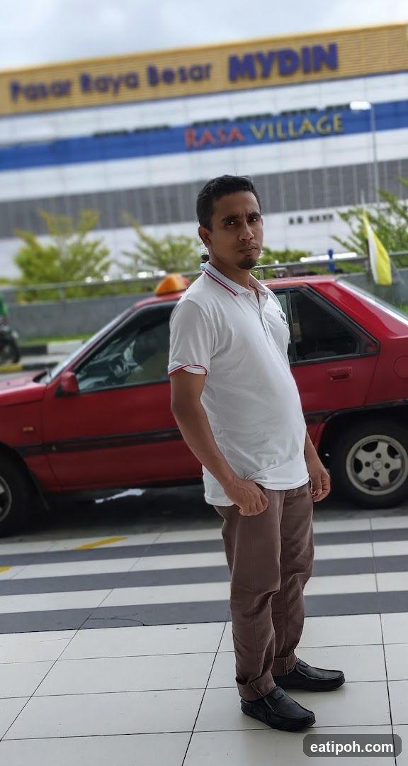 Man standing outside Mydin supermarket