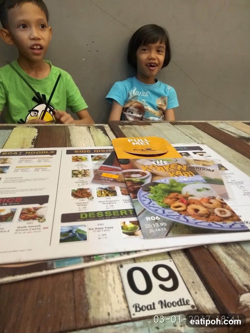 Two children at a restaurant table