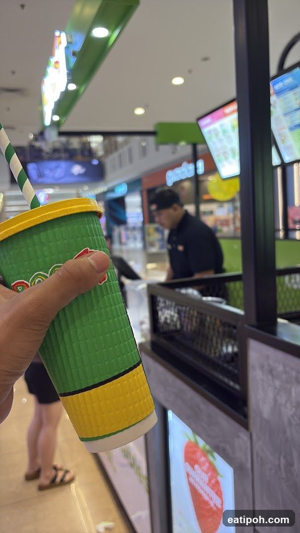Hand holding drink cup in shopping mall