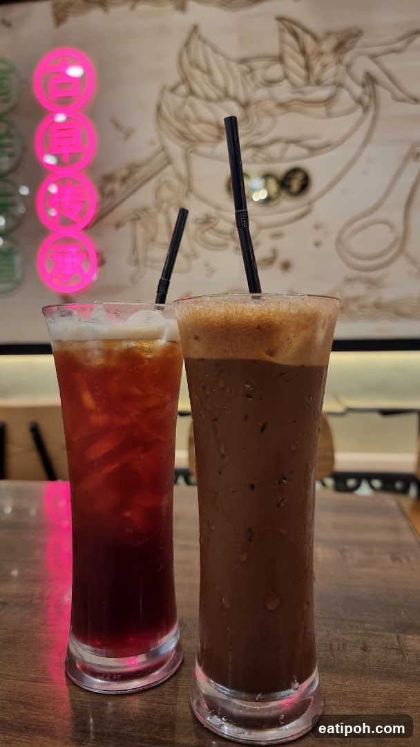 Two iced beverages on a wooden table