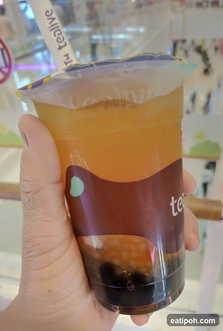 Hand holding a Tealive bubble tea cup