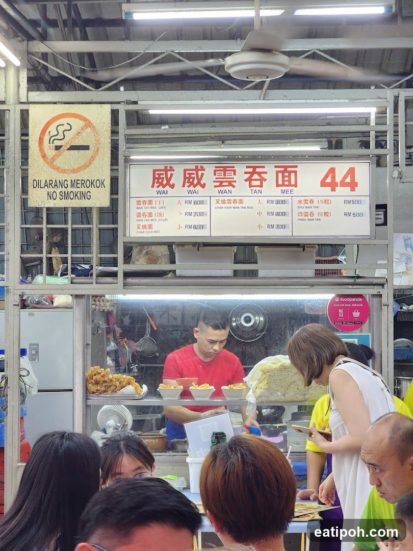 Food stall interior with customers and staff