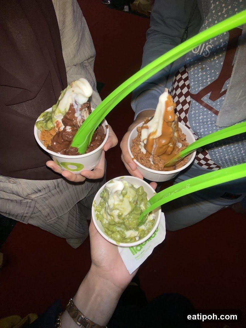 Frozen yogurt cups with green spoons