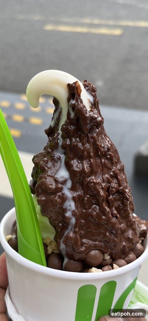 Soft serve dessert with chocolate and white topping