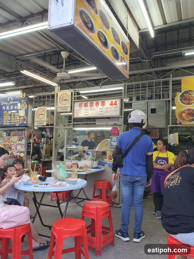 Food stall interior with customers and staff