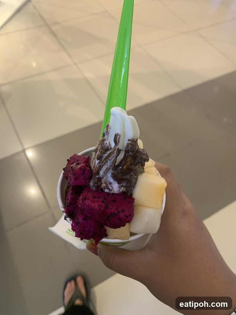 Hand holding frozen yogurt cup