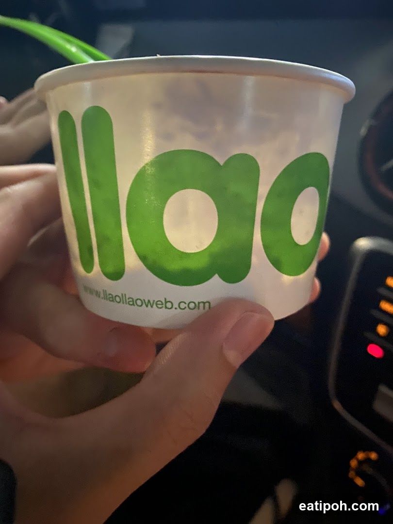 Hand holding a branded cup