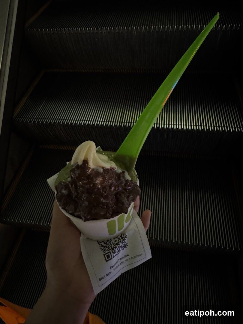 Hand holding dessert with spoon