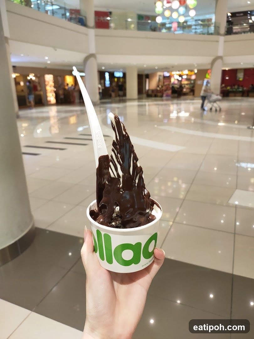 Hand holding frozen dessert in shopping mall