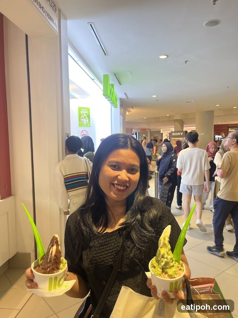 Woman holding ice cream cups in shopping mall