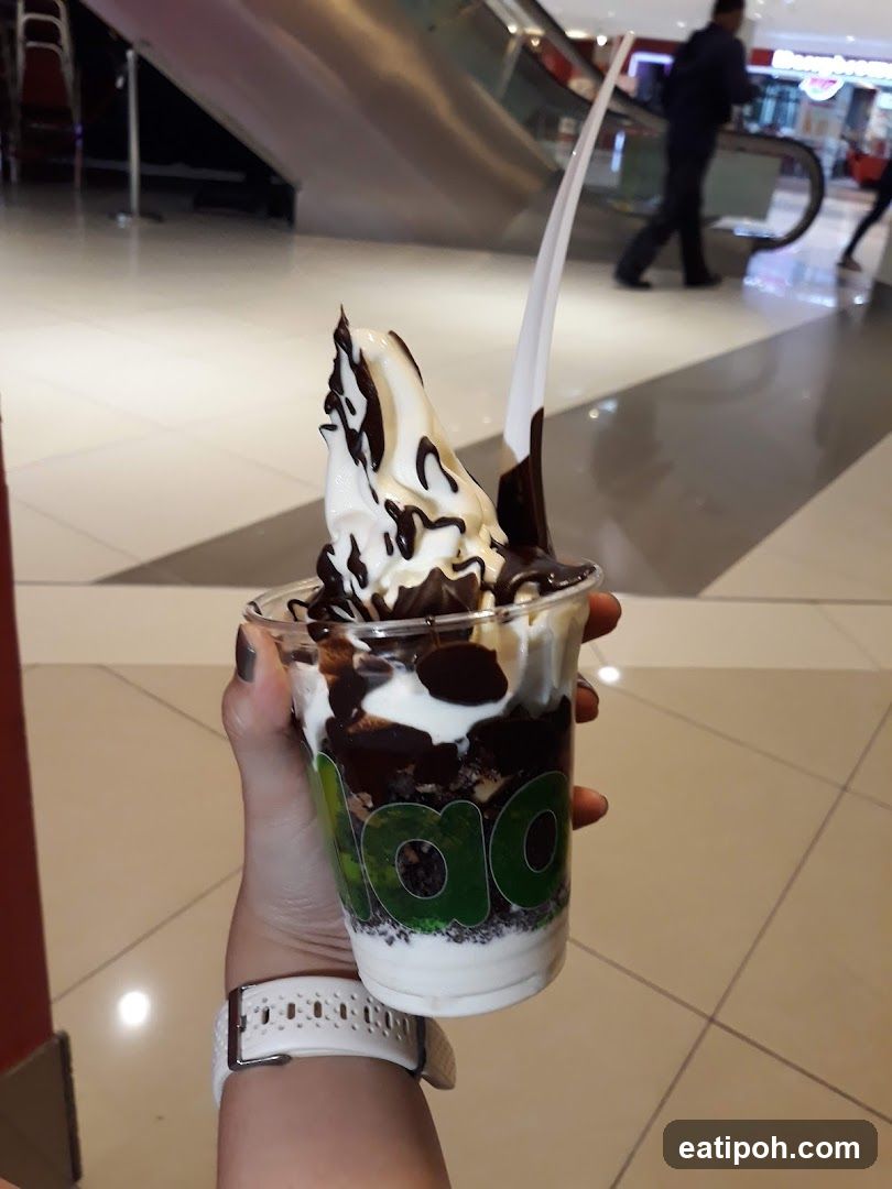 Hand holding dessert in shopping mall