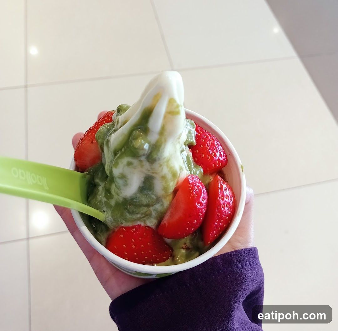Hand holding frozen yogurt cup