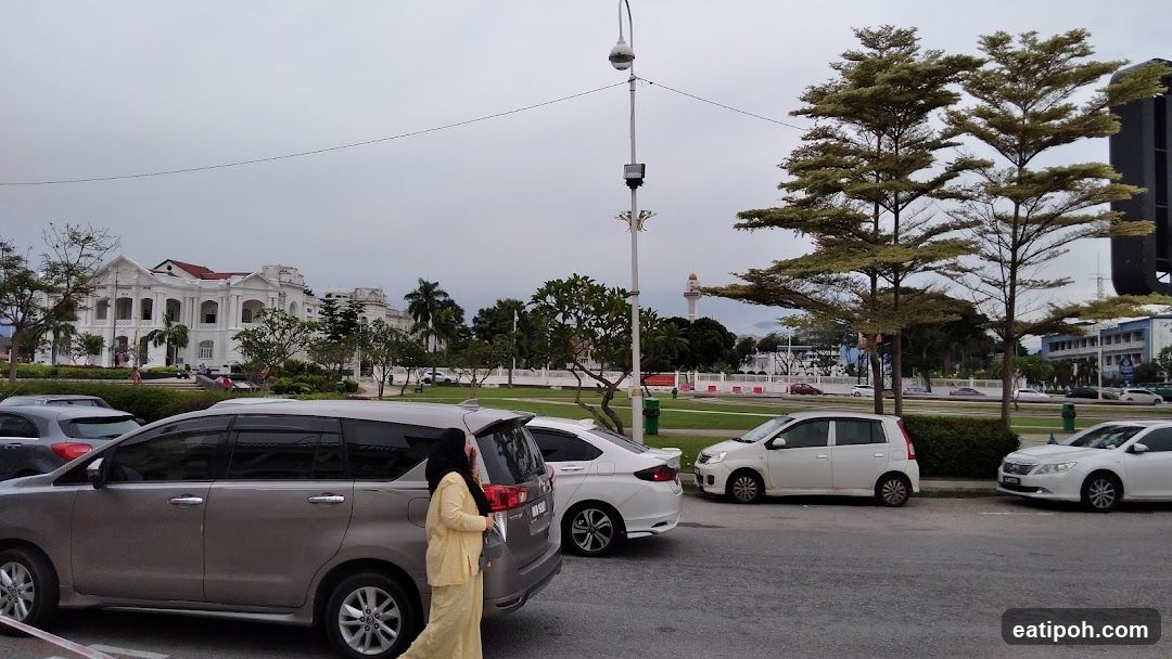 Outdoor parking area with vehicles and buildings