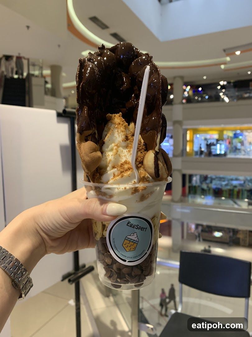 Hand holding dessert in shopping mall
