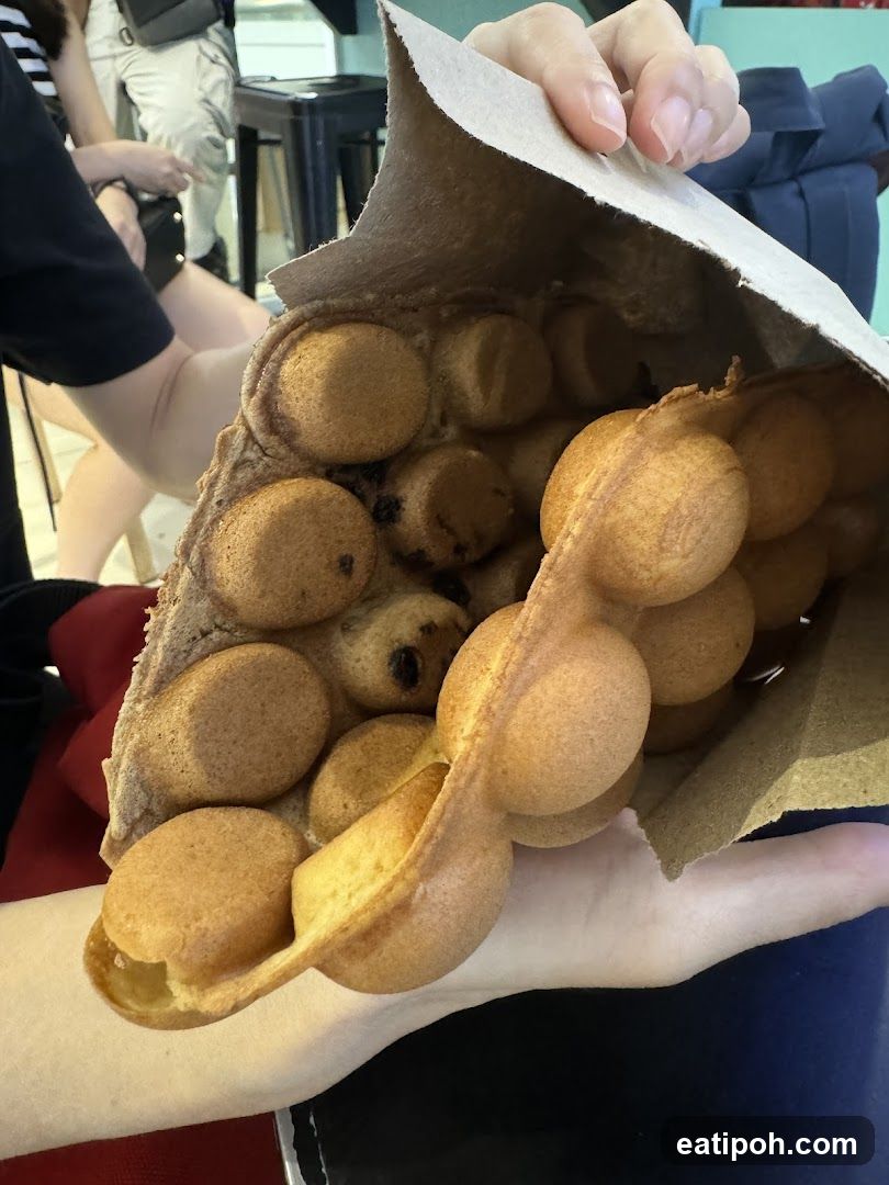Hand holding egg waffle