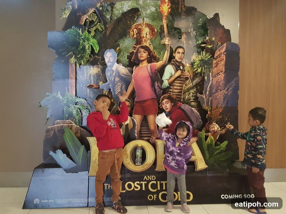 Children posing in front of movie poster