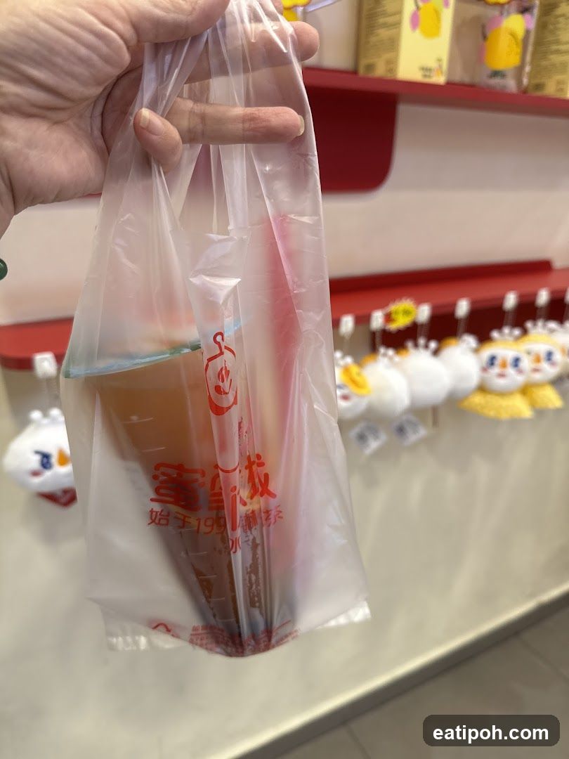 Hand holding drink bag in store