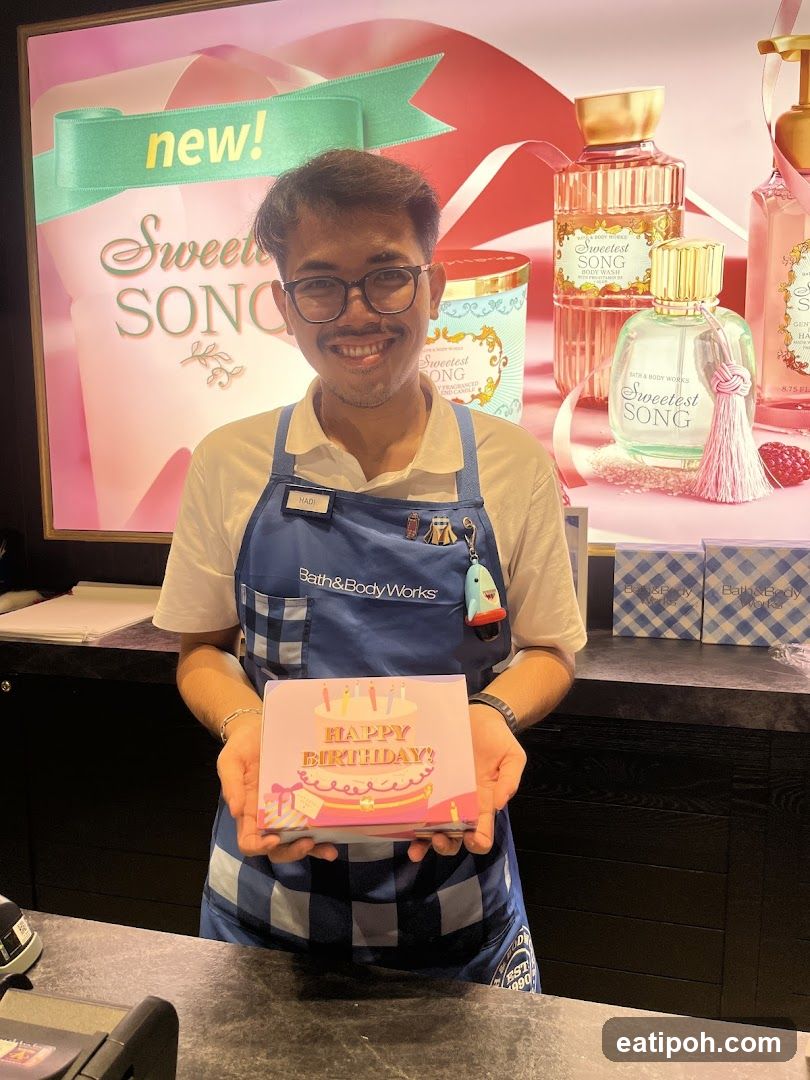 Bath & Body Works employee holding birthday gift box