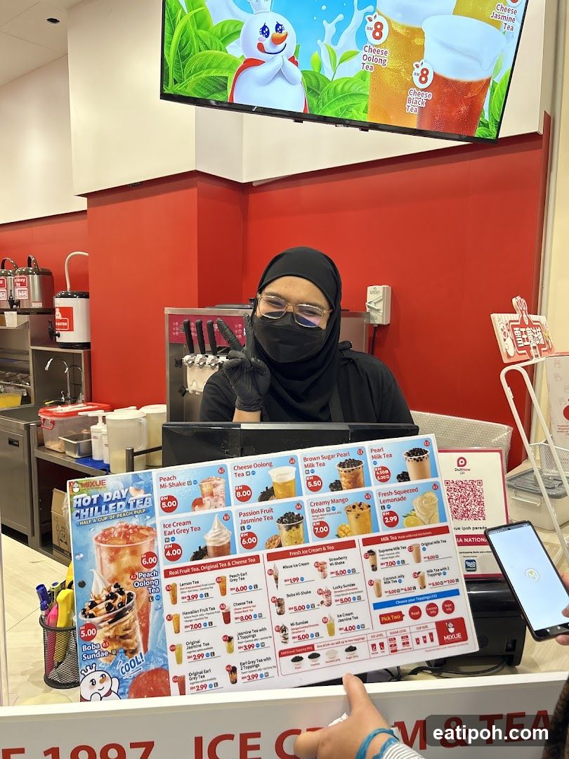 Staff at counter holding menu