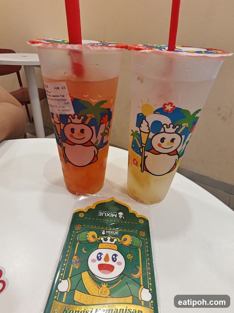 Two beverages with branded cups and a promotional card on a table