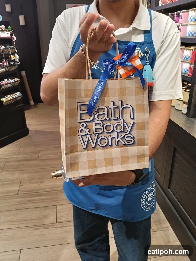 Bath & Body Works employee holding shopping bag