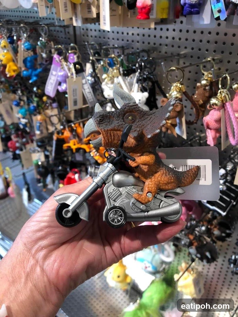 Hand holding dinosaur keychain