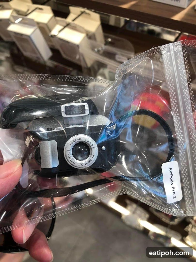 Hand holding camera in plastic bag