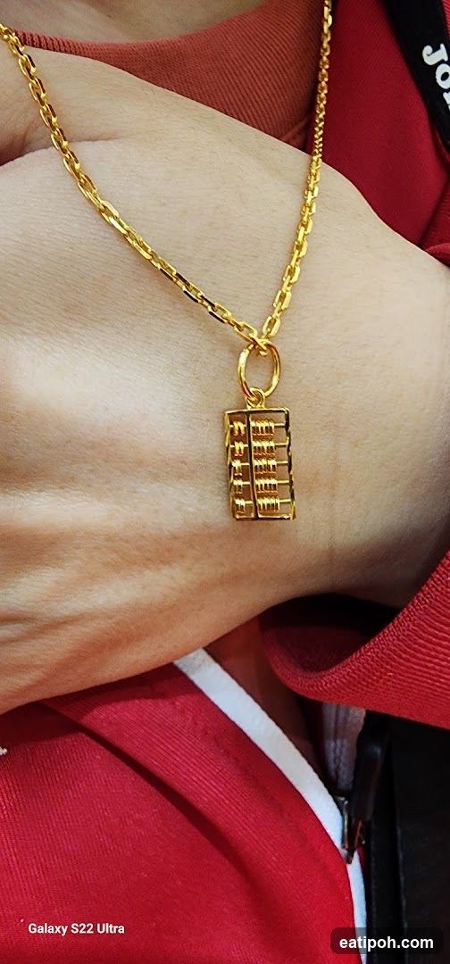 Gold necklace with abacus pendant