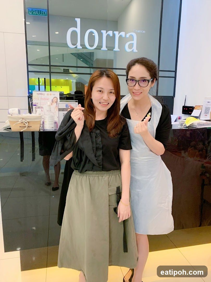 Two women posing in front of a store entrance