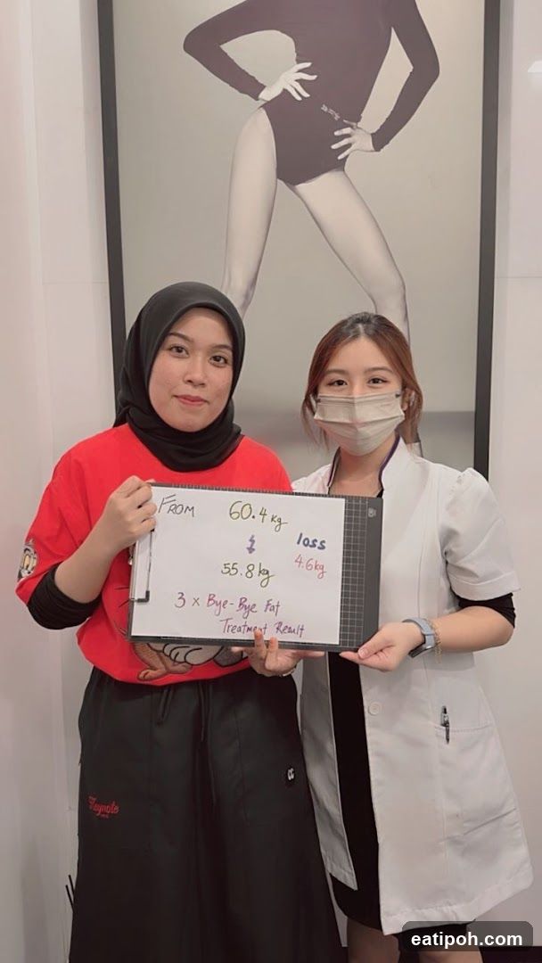 Two women holding a treatment result board