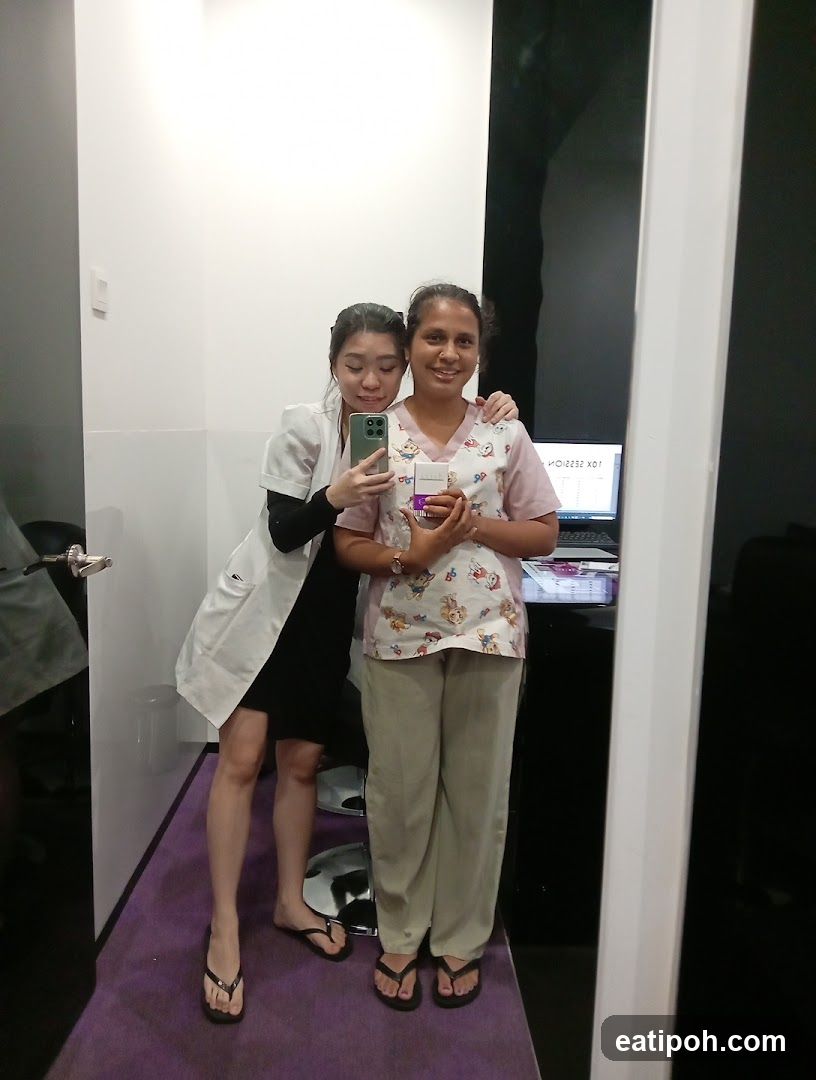 Two individuals posing in an indoor setting