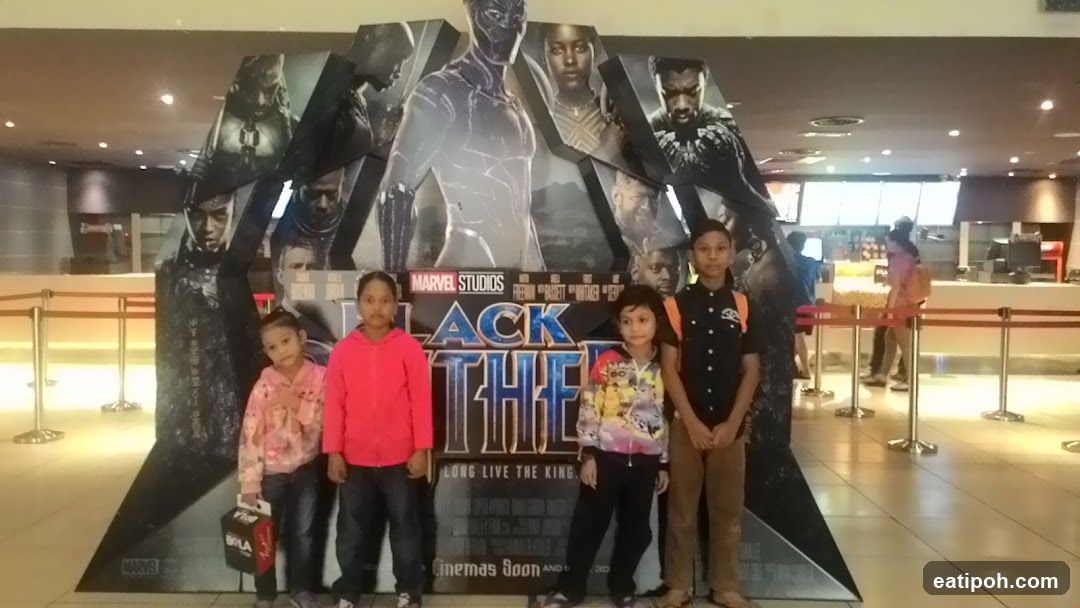 Children posing in front of movie poster
