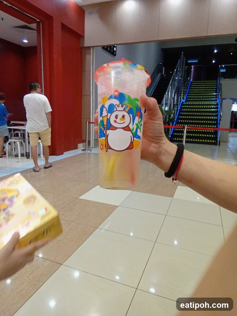 Hand holding drink in shopping mall