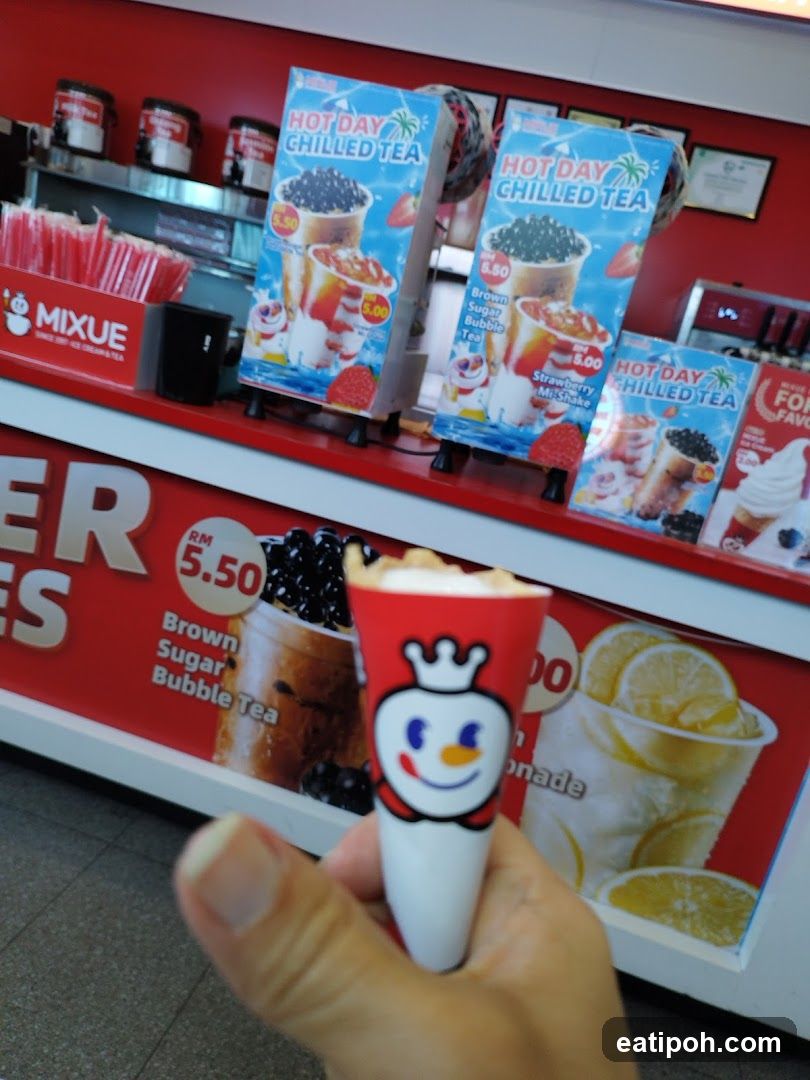 Hand holding branded drink cup in front of store counter