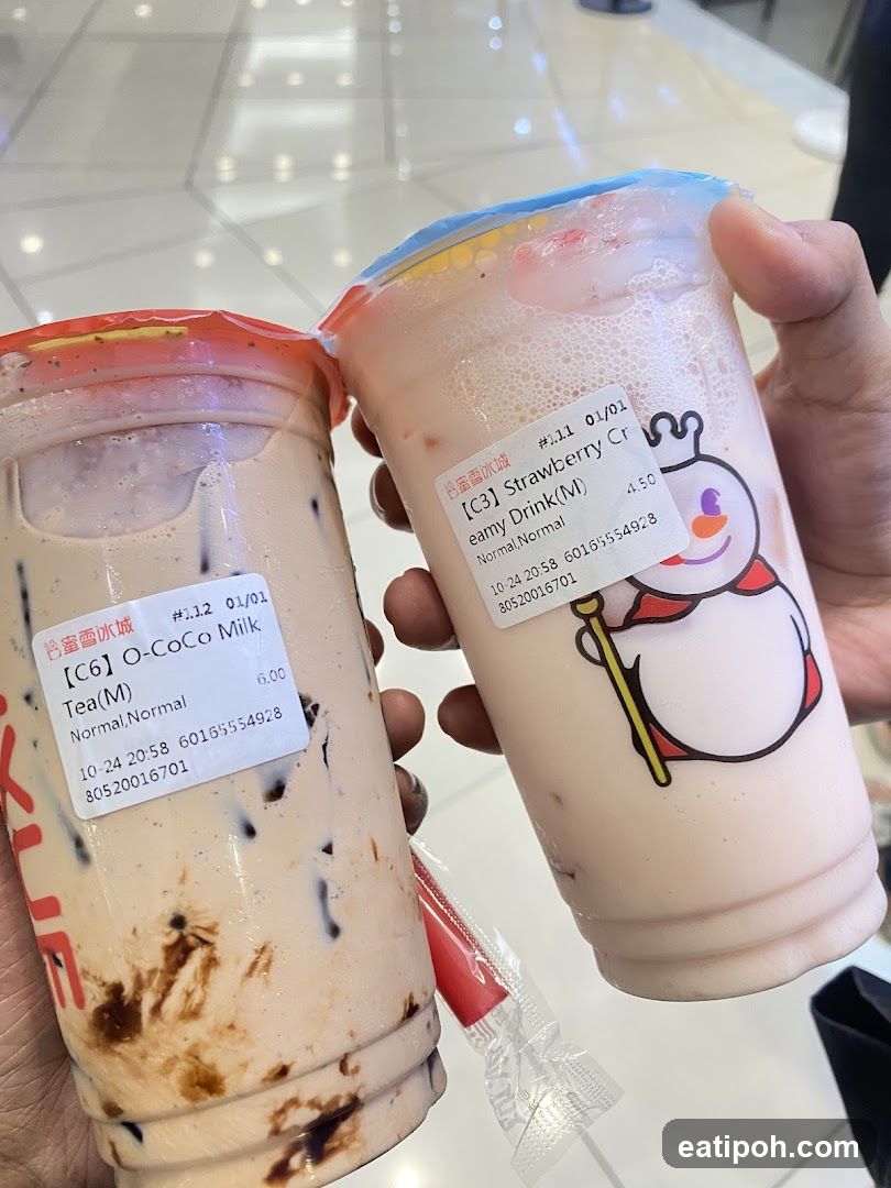 Two bubble tea drinks held in hands