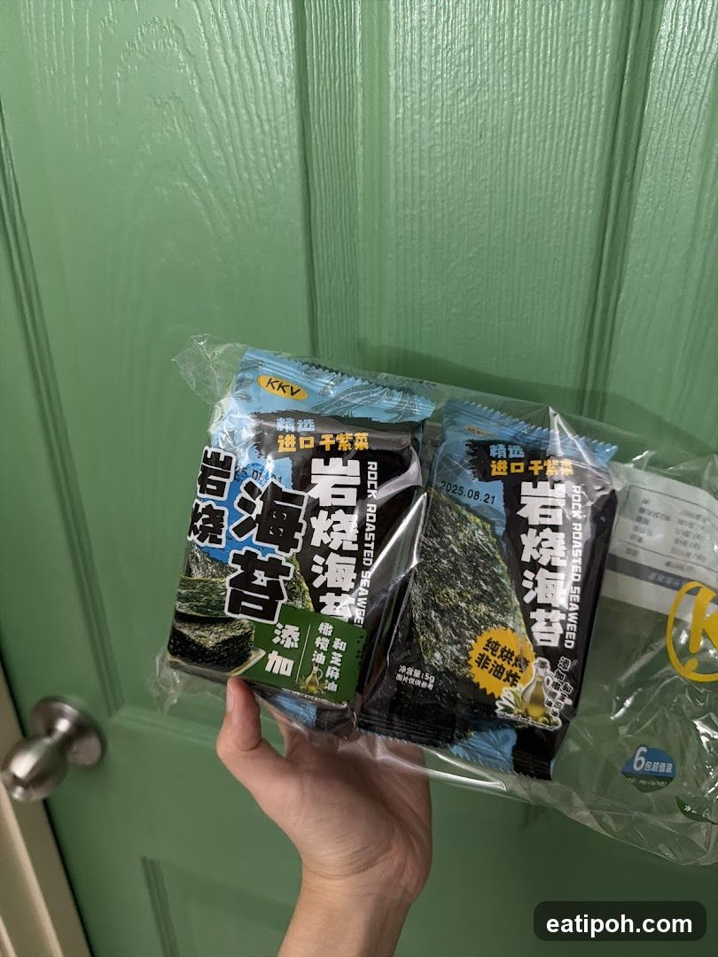 Hand holding packaged seaweed snacks