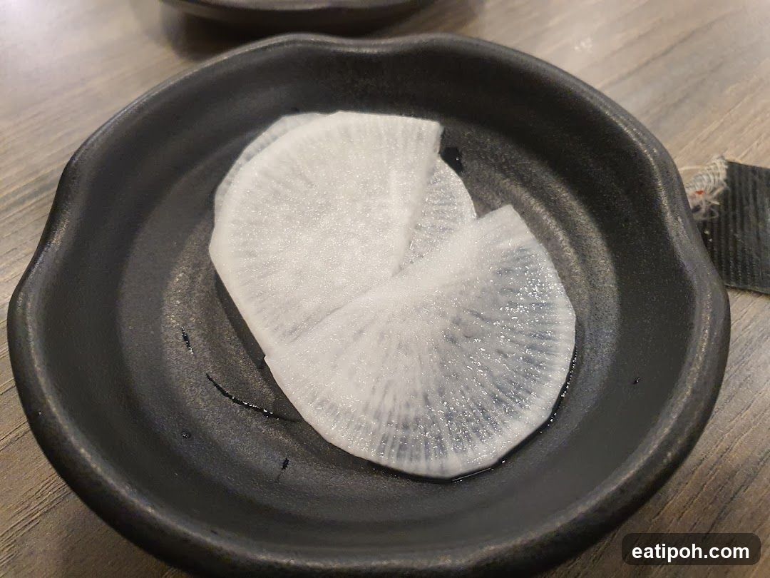 Radish slices on a black ceramic plate