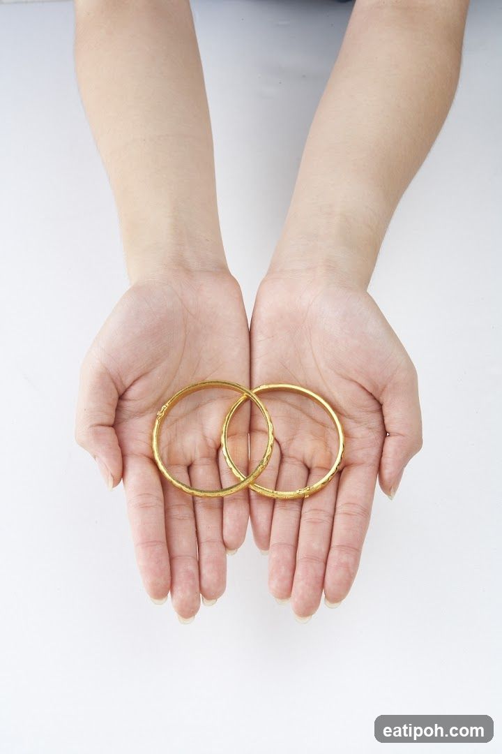 Hands Holding Gold Bangles