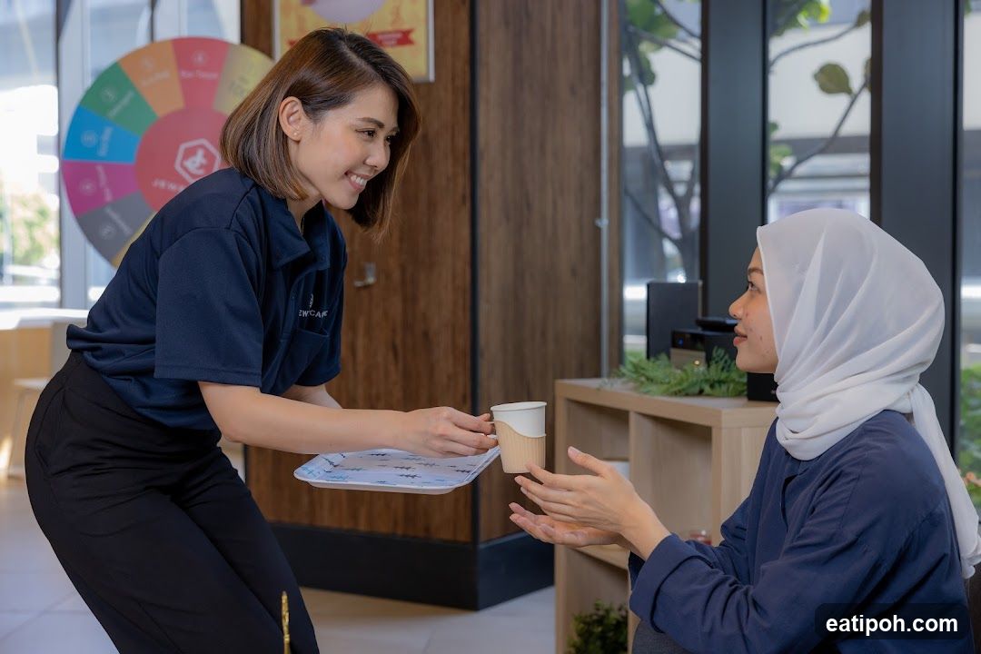 Staff serving customer in café