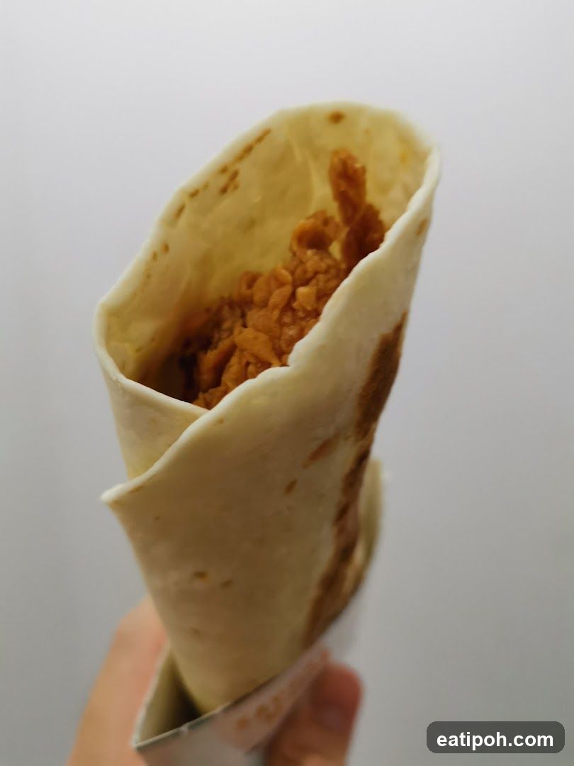 Hand holding a wrapped food item
