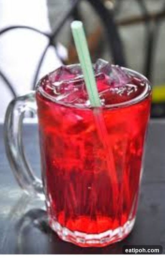 Red beverage in glass mug with straw