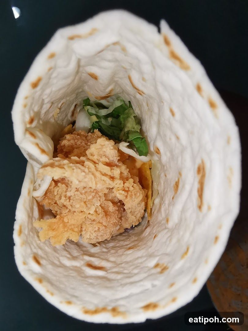 Taco with fried chicken and lettuce