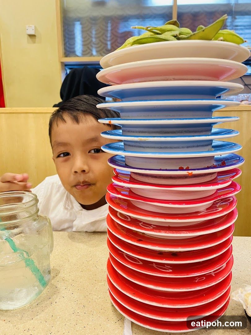 Child at dining table with stacked plates